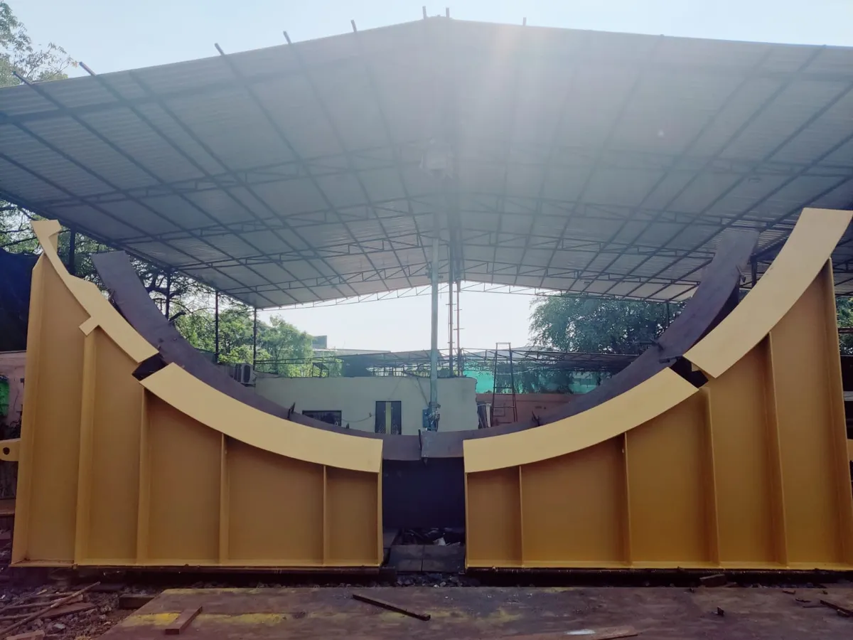 Large curved saddle supports fabricated, finished and prepared for movement.